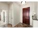 Bright entryway with tile flooring, a decorative front door, and access to other rooms at 23108 N Pedregosa Dr, Sun City West, AZ 85375