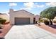 Attractive home exterior featuring a spacious driveway, mature landscaping, and a charming facade at 23108 N Pedregosa Dr, Sun City West, AZ 85375