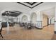 Elegant dining area with herringbone floors, decorative archways, and abundant seating, perfect for gatherings at 23108 N Pedregosa Dr, Sun City West, AZ 85375