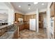 Well-lit kitchen with granite counters, wood cabinets, and stainless steel appliances at 23108 N Pedregosa Dr, Sun City West, AZ 85375