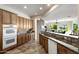Open kitchen with granite countertops, stainless steel appliances, and eat-in bar at 23108 N Pedregosa Dr, Sun City West, AZ 85375