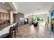 Open-concept living room with tile flooring, fireplace, and views of golf course at 23108 N Pedregosa Dr, Sun City West, AZ 85375