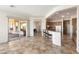 Spacious living room featuring tile flooring, patio access, and open views of the kitchen at 23108 N Pedregosa Dr, Sun City West, AZ 85375
