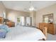 Well-lit main bedroom featuring neutral colors, ceiling fan, and wood furniture at 23108 N Pedregosa Dr, Sun City West, AZ 85375