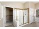 Enclosed glass shower with gold trim and tiled floor located near the walk-in closet and bedroom at 23108 N Pedregosa Dr, Sun City West, AZ 85375