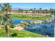 Lush golf course community features scenic lakes, palm trees, and mountain views at 3183 N 159Th N Ave, Goodyear, AZ 85395