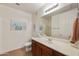 Bright bathroom with a large mirror, dark cabinetry, and a shower with glass doors at 3330 S Gilbert Rd # 2090, Chandler, AZ 85286