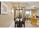 Dining area leading to a living room and balcony with natural lighting at 3330 S Gilbert Rd # 2090, Chandler, AZ 85286