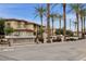 Exterior of Santana Ridge community with lush landscaping, palm trees, and well-maintained buildings at 3330 S Gilbert Rd # 2090, Chandler, AZ 85286