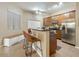 Well-lit kitchen with stainless steel appliances, a breakfast bar, and ample cabinet space at 3330 S Gilbert Rd # 2090, Chandler, AZ 85286