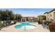 Beautiful community pool with surrounding lounge chairs and landscaped grounds at 3330 S Gilbert Rd # 2090, Chandler, AZ 85286