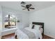 Bright bedroom featuring hardwood floors, a ceiling fan, and unique arched window at 3544 E Tonto Ln, Phoenix, AZ 85050