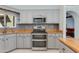 Well-lit kitchen featuring stainless steel appliances, gray cabinetry, and granite countertops at 3544 E Tonto Ln, Phoenix, AZ 85050