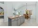 Bright kitchen with white walls, gray cabinets, and a center island adjacent to the dining area at 3544 E Tonto Ln, Phoenix, AZ 85050