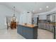 Open kitchen with gray cabinets, stainless appliances, a central island, and a dining area at 3544 E Tonto Ln, Phoenix, AZ 85050