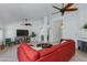 Spacious living room featuring tile floors, ceiling fans, and arched doorways at 3544 E Tonto Ln, Phoenix, AZ 85050