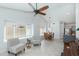 Open-concept living room connecting to dining and kitchen with tile floors and bright windows at 3544 E Tonto Ln, Phoenix, AZ 85050