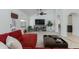 Bright living area featuring white walls, tiled floors, a ceiling fan, and backyard access at 3544 E Tonto Ln, Phoenix, AZ 85050