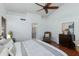 Bright main bedroom featuring a ceiling fan, hardwood floors, and ensuite bathroom at 3544 E Tonto Ln, Phoenix, AZ 85050