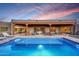 Beautiful backyard with a pool, covered patio, lounge furniture, and fire pit perfect for entertaining and relaxation at 36190 N Creek View Ln, Cave Creek, AZ 85331