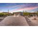 Modern home exterior featuring a paver driveway, desert landscaping, and a spacious three-car garage at 36190 N Creek View Ln, Cave Creek, AZ 85331