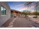 Front elevation with a wooden front porch and desert landscaping with stone walkway at 36190 N Creek View Ln, Cave Creek, AZ 85331