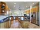 Kitchen features custom cabinets, granite countertops and island, and stainless-steel appliances at 36190 N Creek View Ln, Cave Creek, AZ 85331