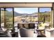 Inviting living room featuring a view of the desert landscape and outdoor lounge seating at 36190 N Creek View Ln, Cave Creek, AZ 85331