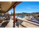 Expansive pool patio with wood supports offers shaded seating areas and unobstructed desert and mountain views at 36190 N Creek View Ln, Cave Creek, AZ 85331
