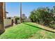 A well-manicured backyard is enclosed with a privacy wall and lush landscaping and trees at 374 E Verde Ln, Phoenix, AZ 85012