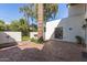 Backyard with a brick patio, a decorative fountain, a built in BBQ, mature landscaping, and a stucco wall at 374 E Verde Ln, Phoenix, AZ 85012