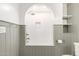 Bathroom features a beautifully tiled shower-tub combination with built in shelving and neutral paint at 374 E Verde Ln, Phoenix, AZ 85012