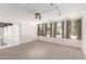 Spacious bonus room with neutral carpet, lots of windows, and open layout at 374 E Verde Ln, Phoenix, AZ 85012