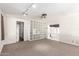 Bonus room features neutral paint, carpet, and a built in bookshelf for storage and decor at 374 E Verde Ln, Phoenix, AZ 85012