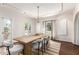 Dining room with white chairs, hanging light fixture, and view into the backyard at 374 E Verde Ln, Phoenix, AZ 85012