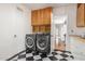 Laundry room featuring washer and dryer and black and white checkered tile flooring at 374 E Verde Ln, Phoenix, AZ 85012