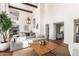 Bright living room with high ceilings and a view into the dining room and kitchen at 374 E Verde Ln, Phoenix, AZ 85012