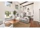 Bright living room with oversized windows, high ceilings, and a connected dining area at 374 E Verde Ln, Phoenix, AZ 85012