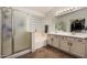 Bathroom with dual sinks, a glass-enclosed shower, and a separate bathtub at 3875 E Juanita Ave, Gilbert, AZ 85234