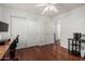 A clean bedroom with wood floors, ample storage, and a doorway into an ensuite bathroom at 3875 E Juanita Ave, Gilbert, AZ 85234