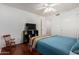 Cozy bedroom featuring wood floors, a ceiling fan, and neutral paint at 3875 E Juanita Ave, Gilbert, AZ 85234