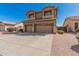 Charming two-story home featuring a three-car garage and desert landscaping at 3875 E Juanita Ave, Gilbert, AZ 85234