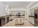 Bright kitchen features granite countertops, stainless steel appliances, and an island with bar stool seating at 3875 E Juanita Ave, Gilbert, AZ 85234