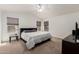 Spacious primary bedroom featuring a ceiling fan, carpet, and multiple windows for natural light at 3875 E Juanita Ave, Gilbert, AZ 85234