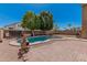 Backyard pool area surrounded by brick and rock, perfect for outdoor enjoyment on a sunny day at 3875 E Juanita Ave, Gilbert, AZ 85234