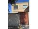 Exterior view of a two-story home featuring a gated entrance and visible house number at 3944 W Camelback Rd, Phoenix, AZ 85019