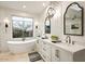 Bright bathroom featuring a modern vanity, soaking tub, and decorative lighting at 39912 N 98Th Way, Scottsdale, AZ 85262
