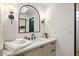 Bathroom vanity with light colored cabinets and modern fixtures at 39912 N 98Th Way, Scottsdale, AZ 85262