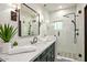 Modern bathroom featuring a tiled shower, dark vanity, and stylish fixtures at 39912 N 98Th Way, Scottsdale, AZ 85262