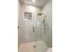Modern shower features decorative tile, glass door, and bronze fixtures at 39912 N 98Th Way, Scottsdale, AZ 85262